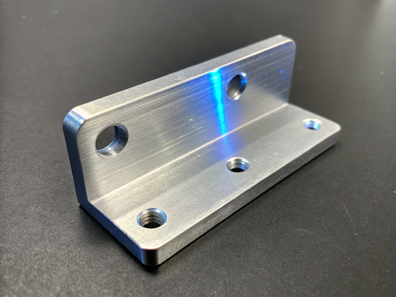 Macro detail of CNC machined 7075 aluminum optic mount